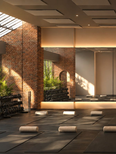 Sunlit studio floor lined with mats and bolsters under south-facing windows